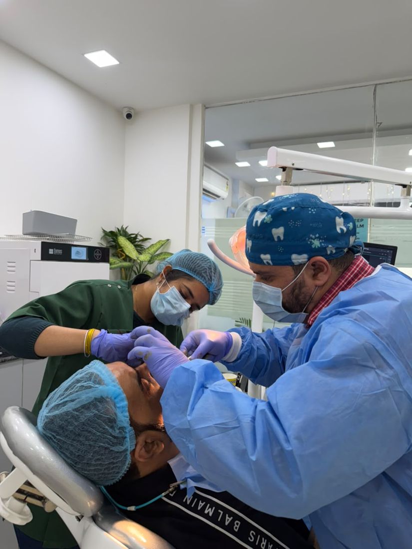 Dental Solutions implantologist and assistant performing implant treatment in a sterile clinic